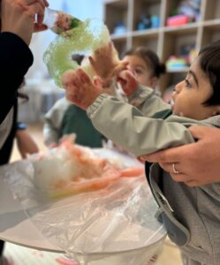 Children playing with soap bubbles created with recycled plastic bottles