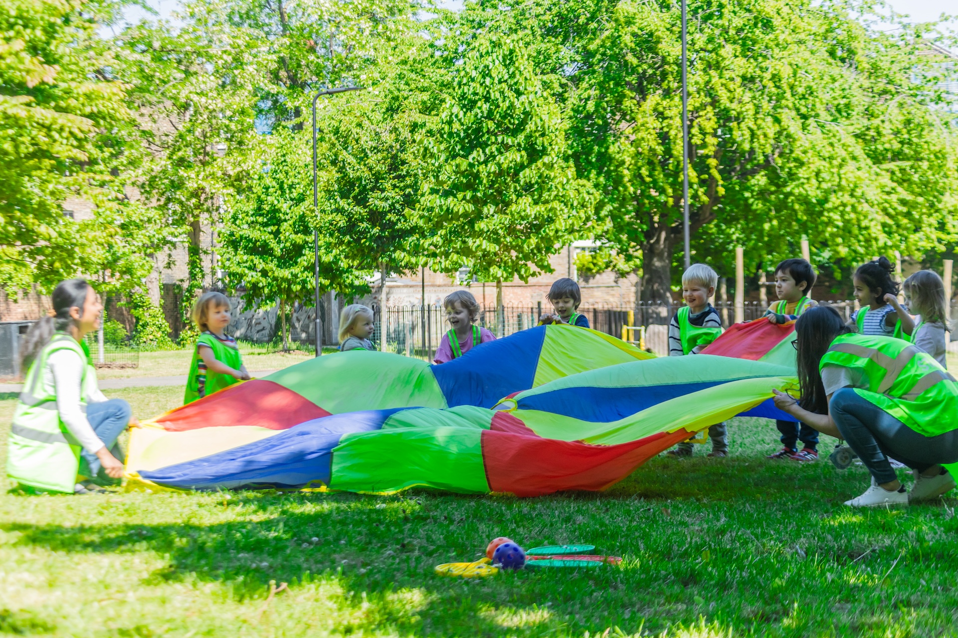 Children playing outdoors in a Finnish preschool setting, exploring nature as part of holistic education