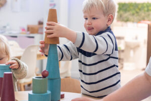 Preschool activities with children counting colourful blocks during playtime