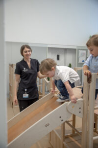 Educator observing children in early childhood education setting