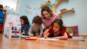Preschool teacher observing child progress as part of curriculum assessment