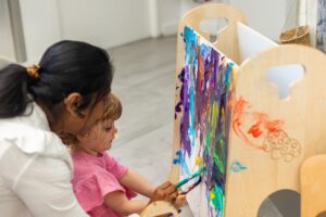 Children exploring creative preschool activities with paint and craft materials