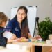 Australian teacher working with children around the table
