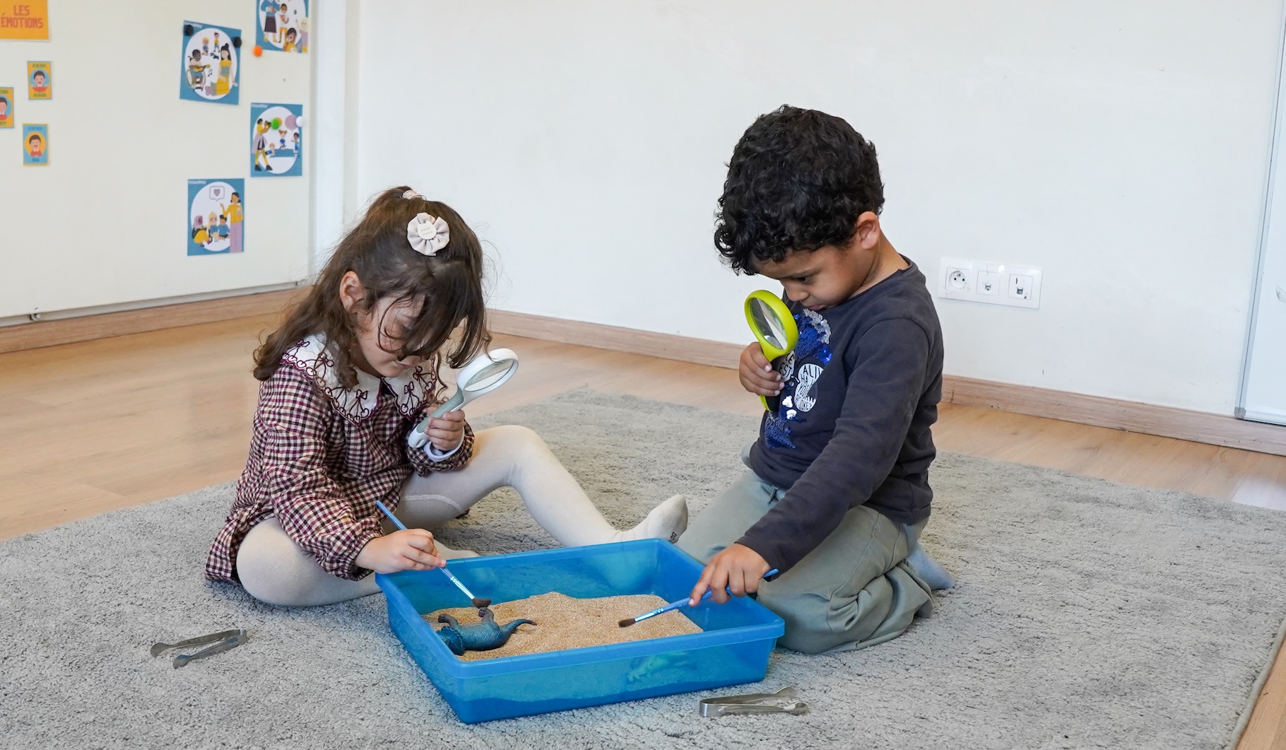 Children engaged in project-based preschool curriculum activities.
