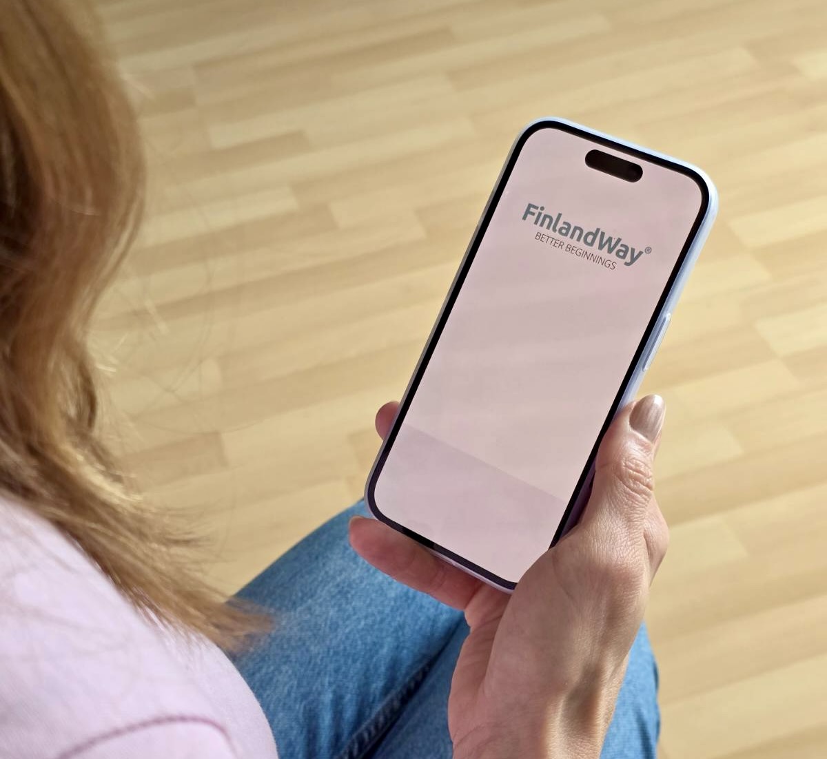 Parent browsing the FinlandWay app at home.
