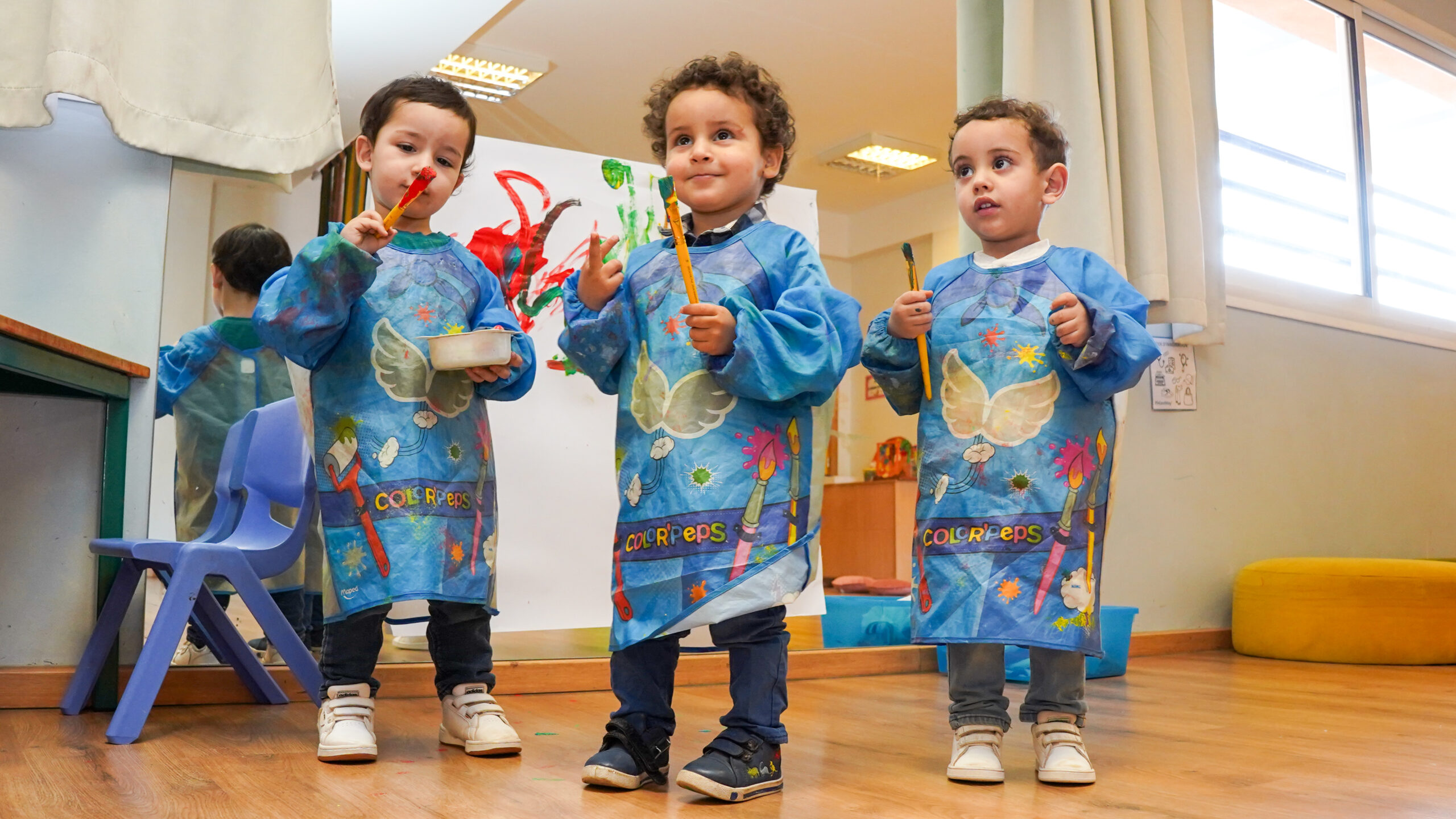 Teacher guiding children during early learning activities in nursery school
