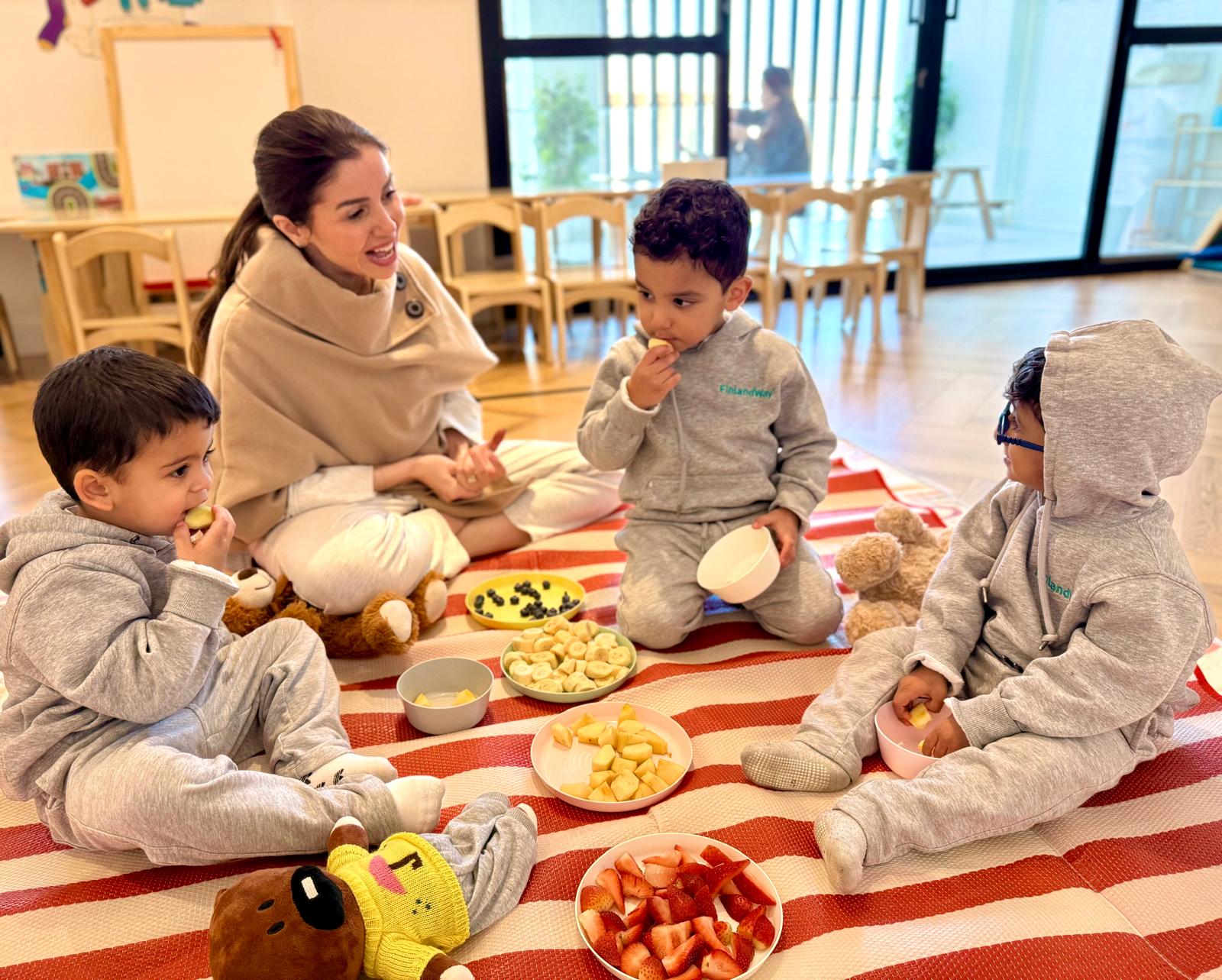 A warm, bright classroom with a young child conveying multi-dimensional development. Natural light, Scandinavian-feel setting.